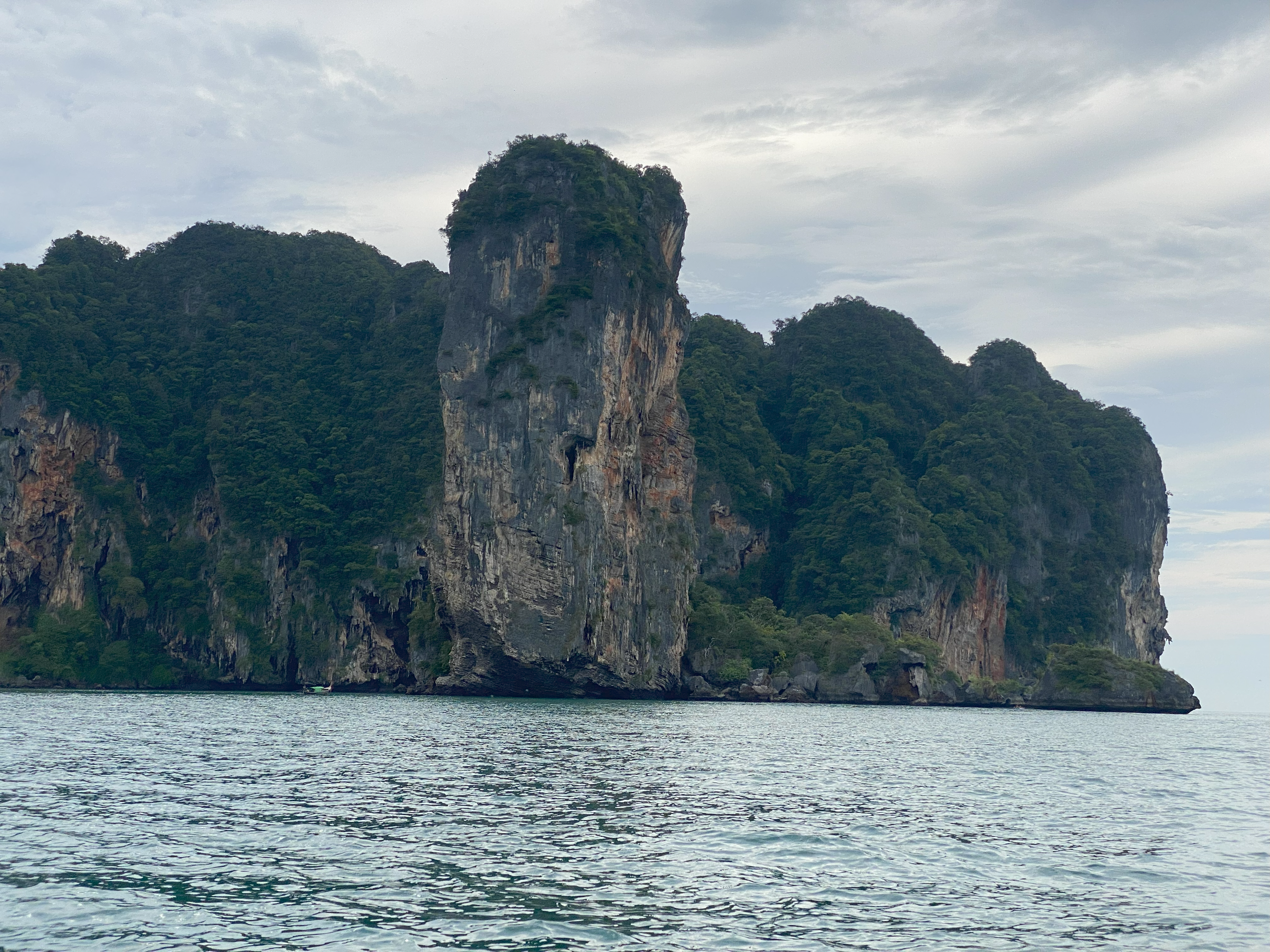 Lone limestone tower rising from the sea near Railay Beach, Krabi, creating an iconic landscape view