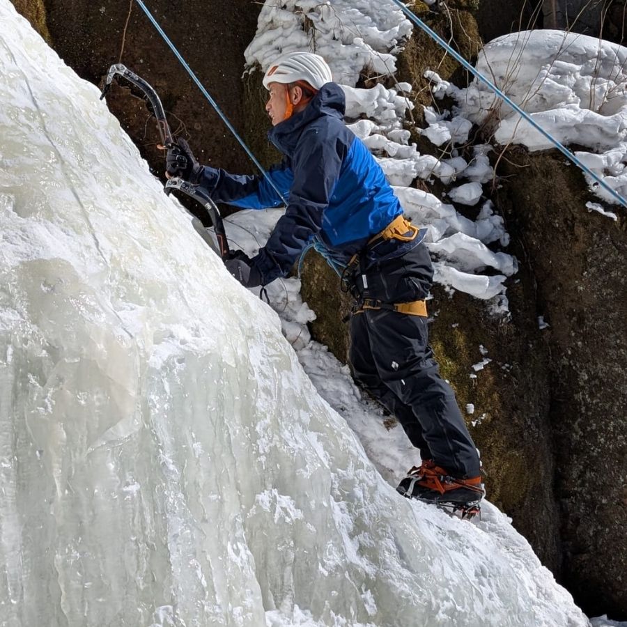 starting first ice climb on frozen waterfall slippery surface