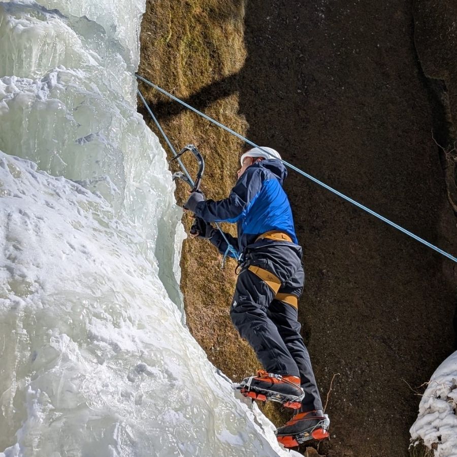 beginner adjusting to ice climbing gear and movement on ice