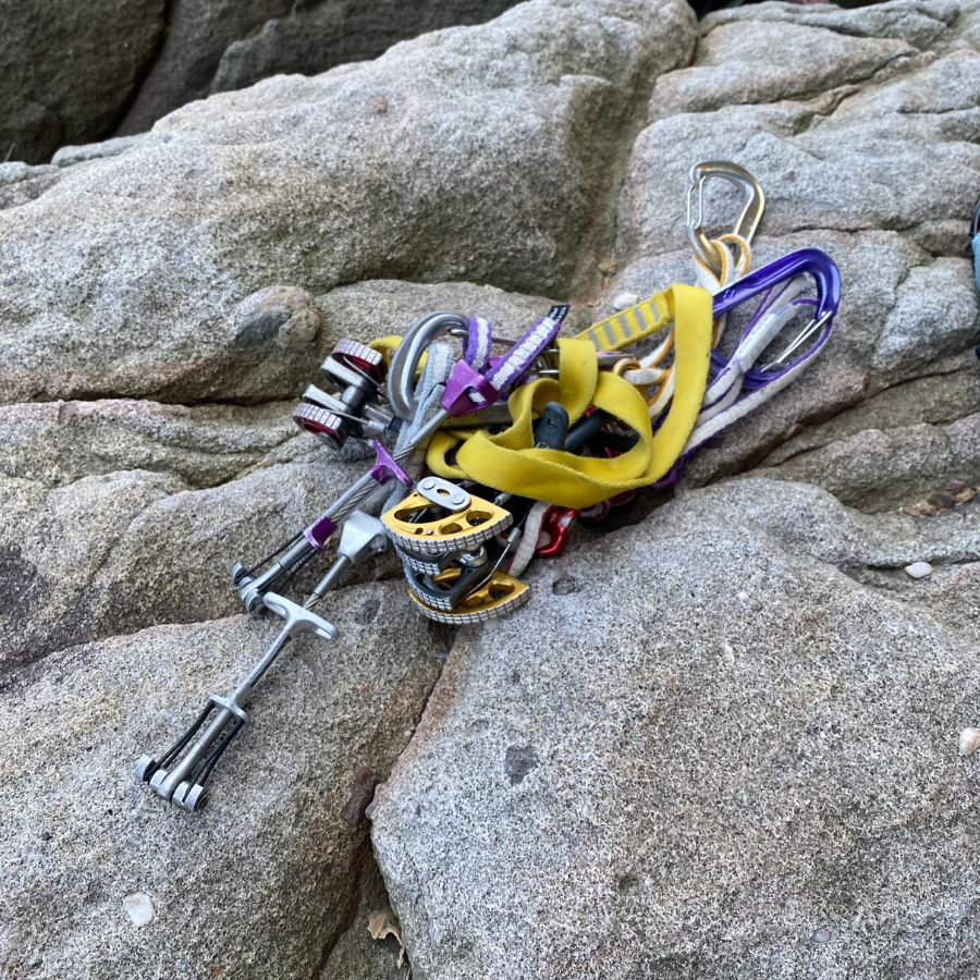 Climber gearing up with safety equipment for rock climbing