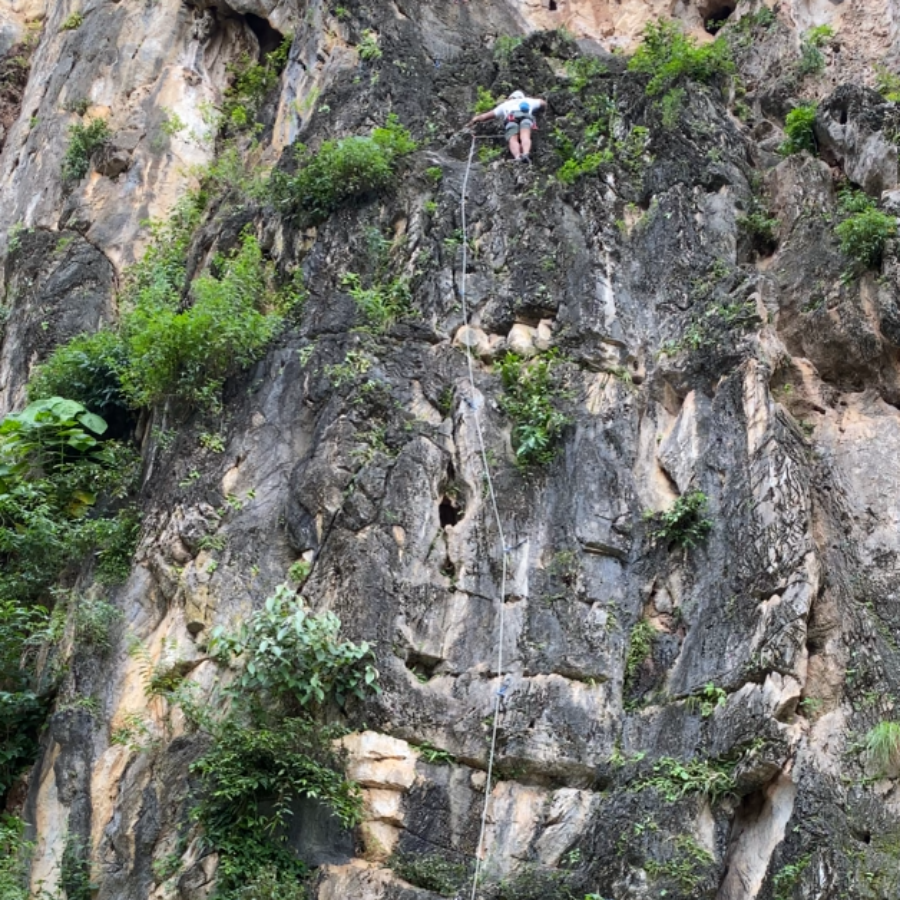 Climber preparing for a long route at Gua Damai