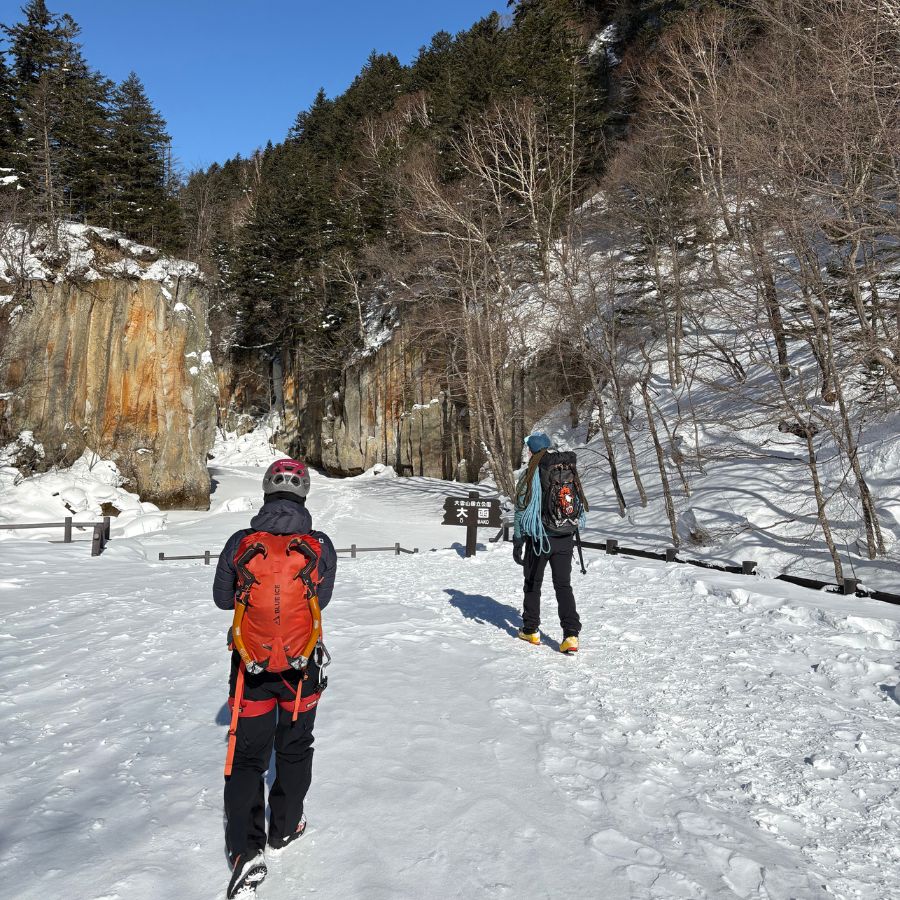 walking through snow toward ice climbing spot in Hokkaido mountains