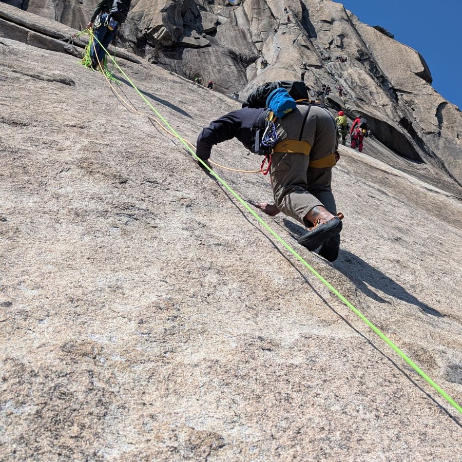 small foothold on granite slab climbing route