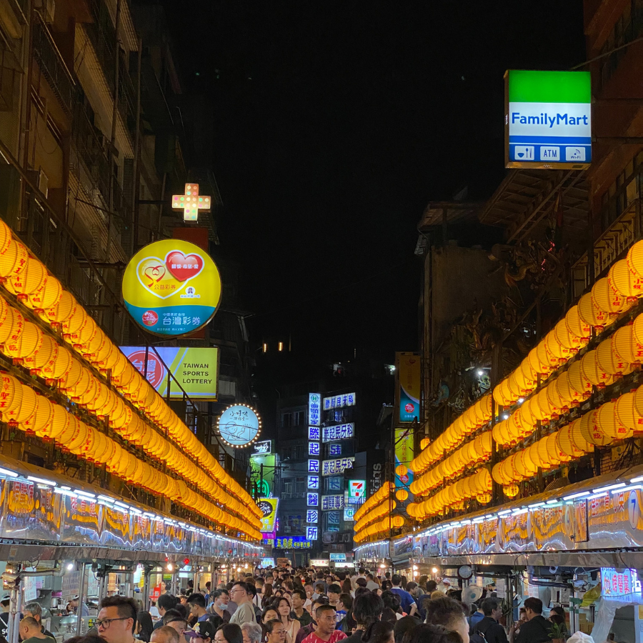 Keelung night market street lit with colorful signs and food stalls
