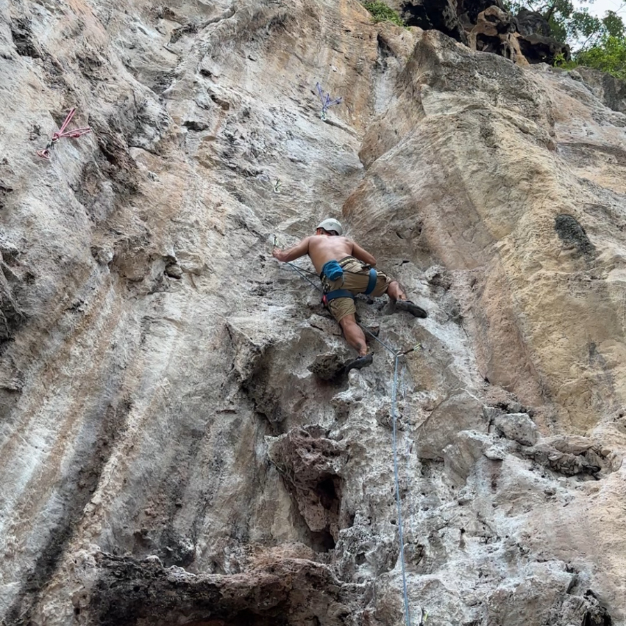 ByrdieOnTheRocks clipping a rope to the bolt after reaching the King Cobra hold on Railay Beach