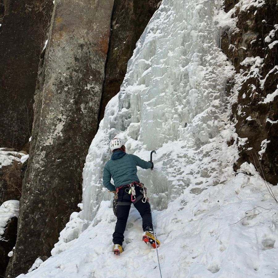 guide demonstrating proper ice axe technique Hokkaido ice climbing