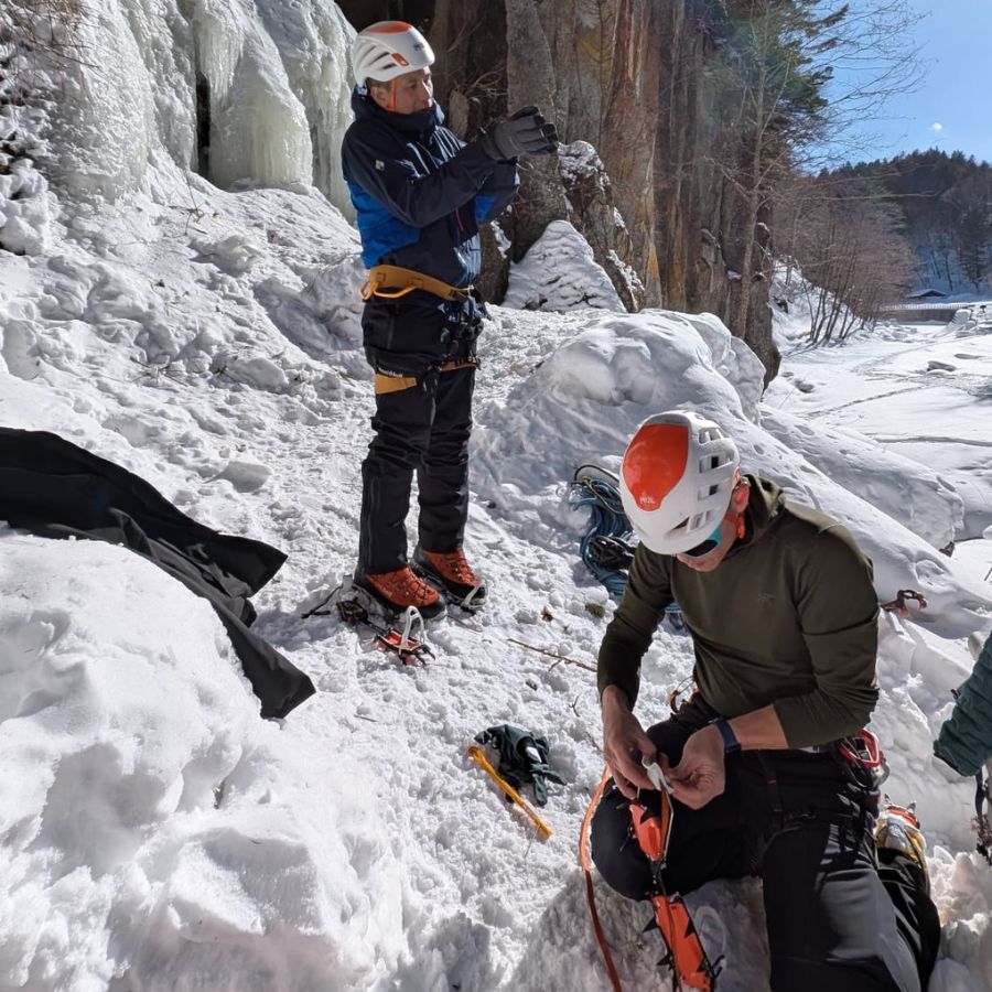 wearing gloves during ice climbing preparation in cold weather