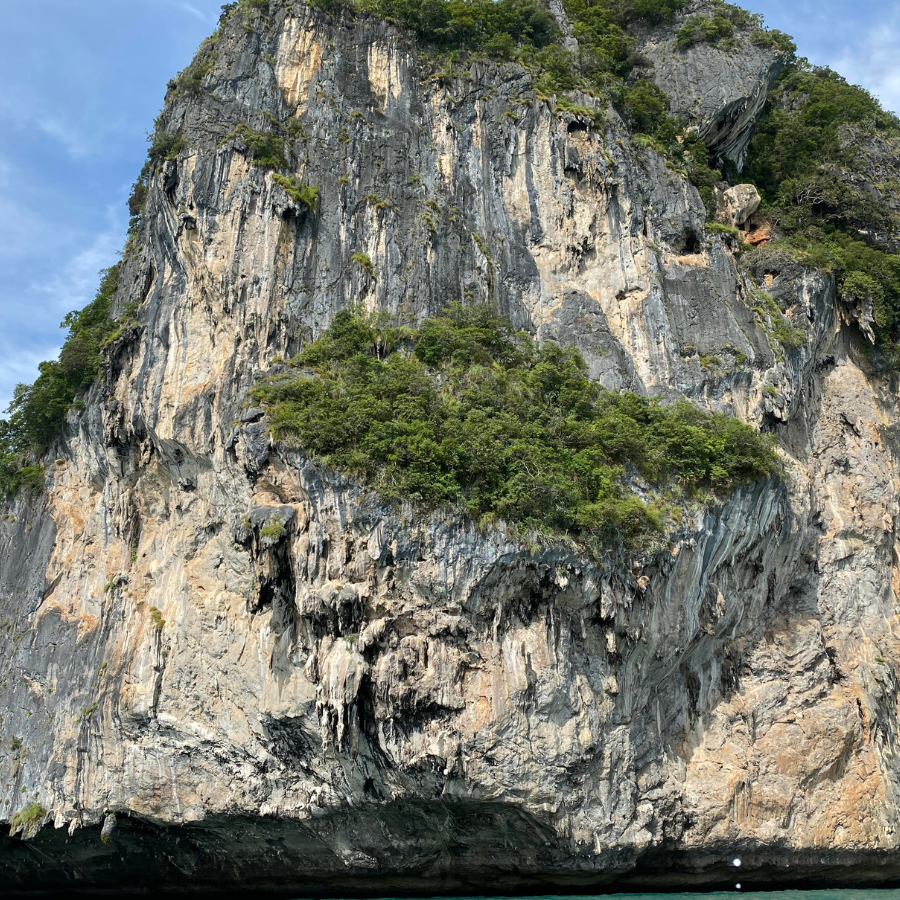 Dramatic limestone cliffs towering over Railay Beach, a stunning climbing destination